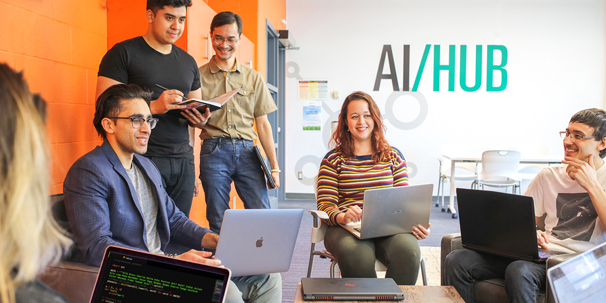 Students working on their laptops at the AI Hub