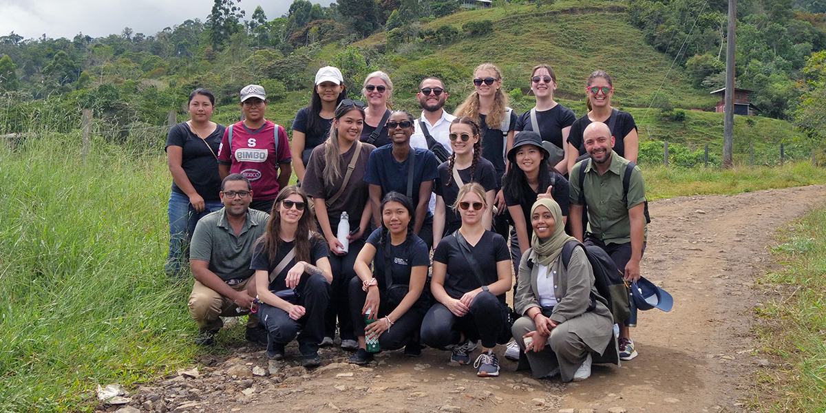 DC students and faculty members pose and smile while standing outside during their trip to Costa Rica.