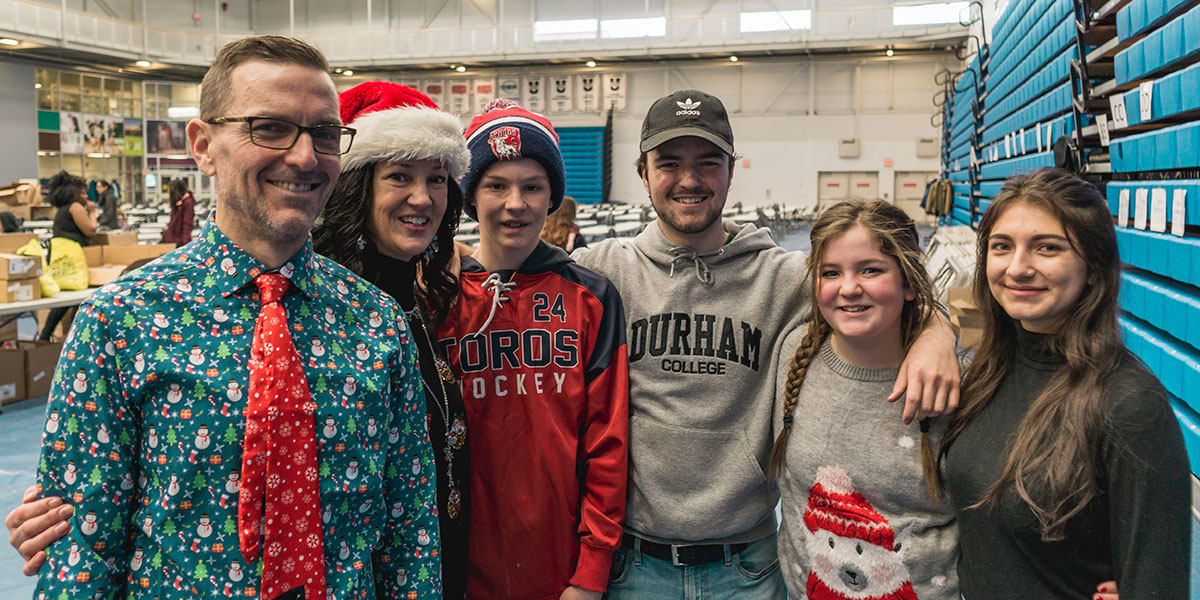 Family at holiday hamper packing drive